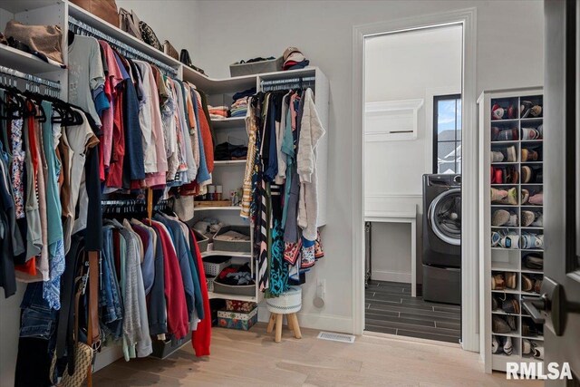 walk in closet featuring washer / dryer and wood finished floors