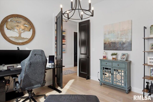 office area with an inviting chandelier, baseboards, and light wood finished floors
