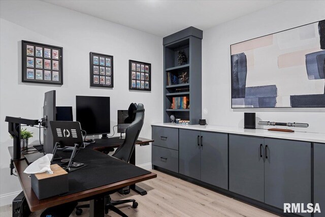 office area with baseboards and light wood-style floors