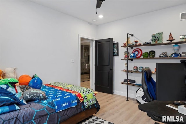 bedroom with light wood-style floors, baseboards, a ceiling fan, and visible vents