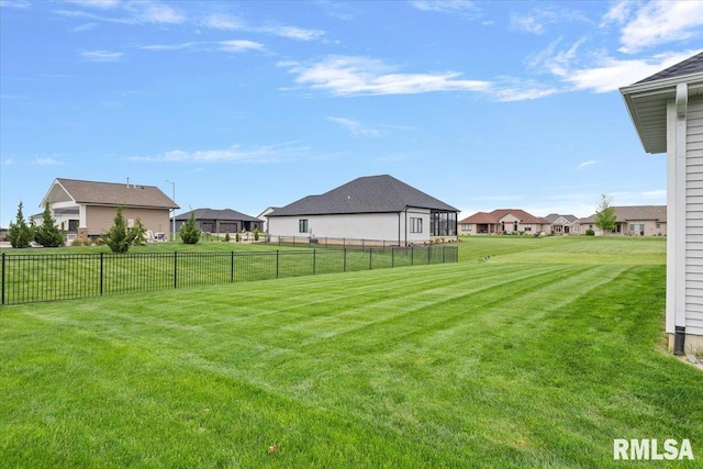 view of yard with fence and a residential view