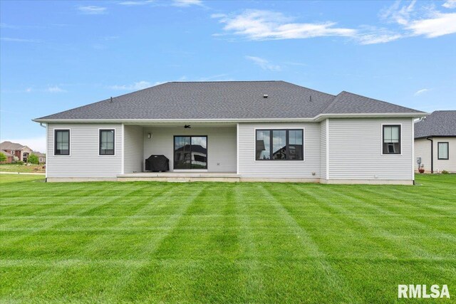 back of house with a patio and a yard