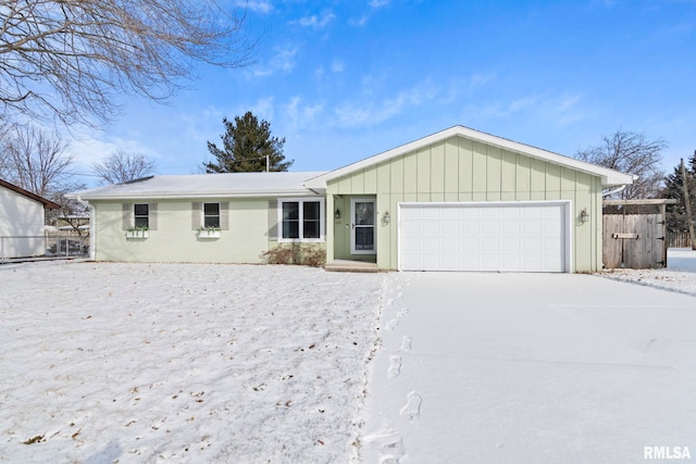 ranch-style home with fence and an attached garage