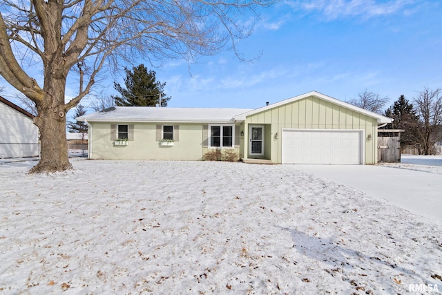 single story home with board and batten siding, driveway, and a garage