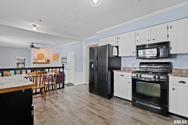 kitchen featuring crown molding, a ceiling fan, black appliances, white cabinetry, and light wood-type flooring