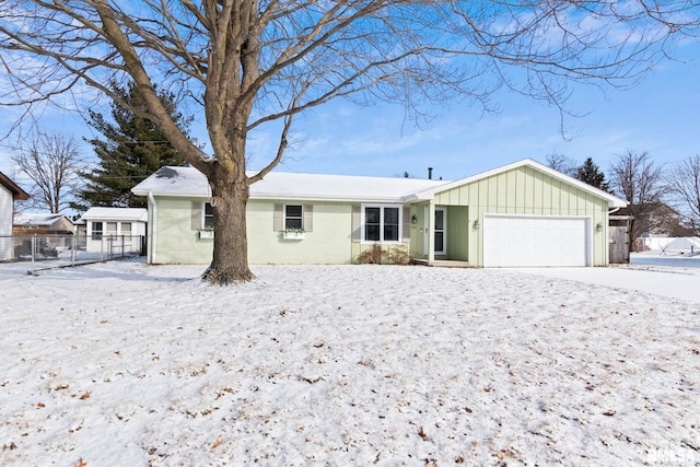 single story home with fence, an attached garage, and board and batten siding