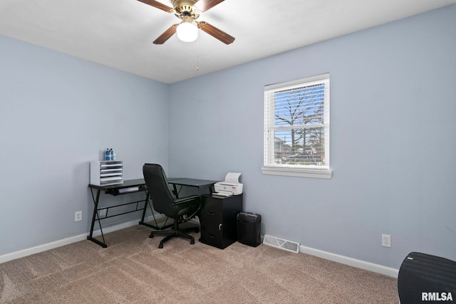 home office with baseboards, visible vents, and light carpet