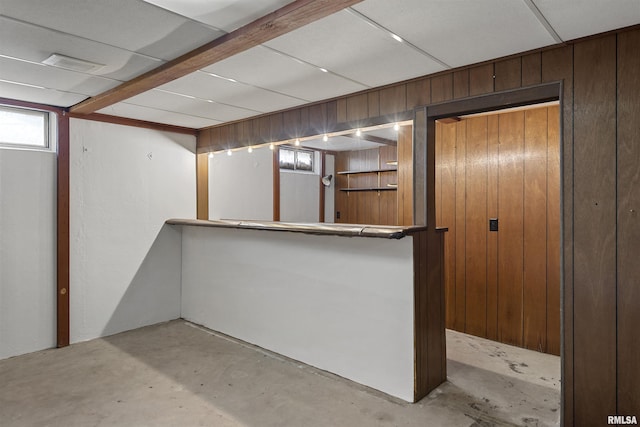 interior space featuring wood walls and concrete floors