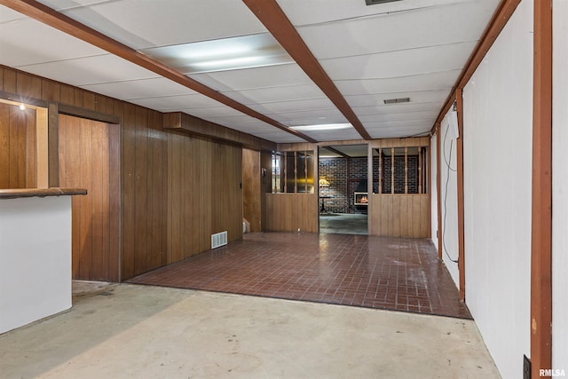 interior space featuring wood walls and visible vents