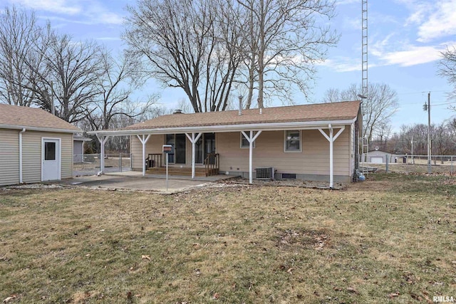 rear view of property with a lawn, a chimney, fence, and cooling unit