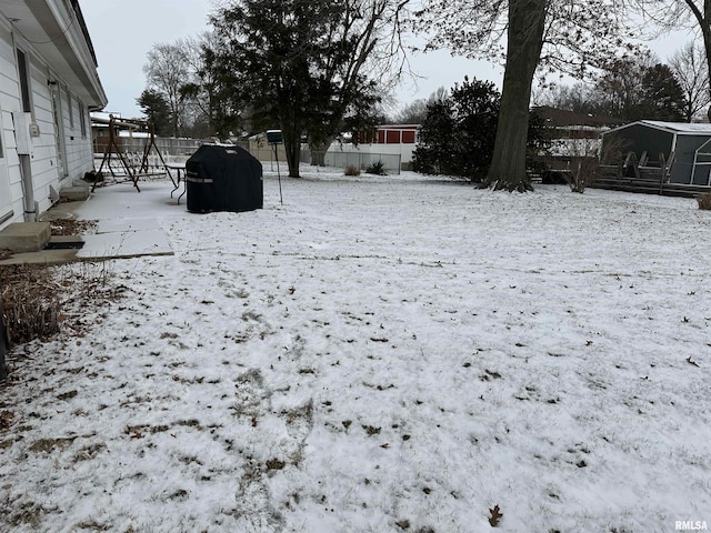 snowy yard featuring fence