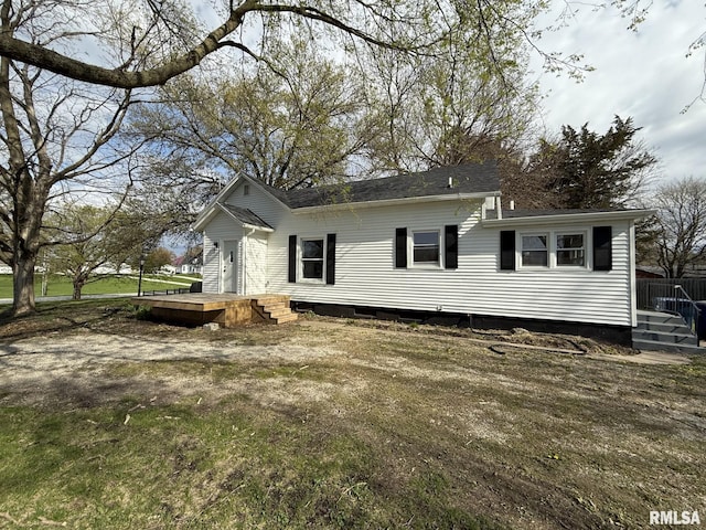 view of side of home featuring roof with shingles