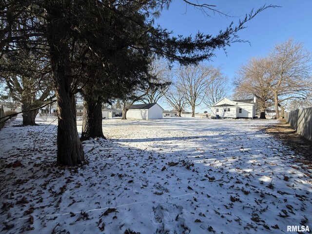 yard covered in snow featuring fence