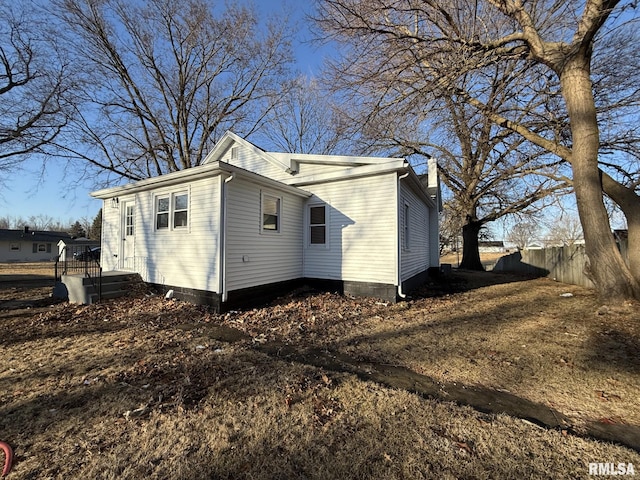 view of home's exterior featuring fence