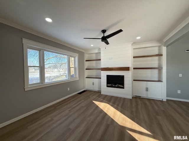 unfurnished living room featuring ornamental molding, ceiling fan, and wood finished floors