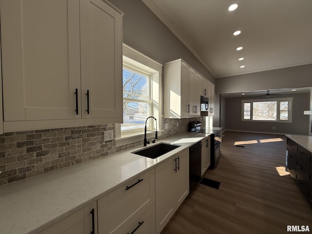 kitchen with white cabinetry, a sink, black appliances, dark wood-style flooring, and recessed lighting