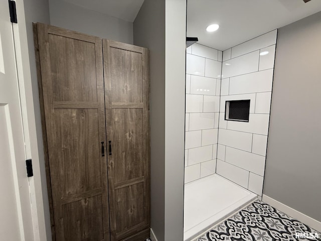 full bath with baseboards, recessed lighting, tile patterned floors, and a tile shower