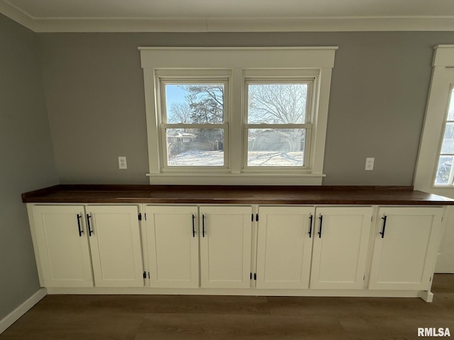 details featuring wood finished floors, crown molding, and baseboards