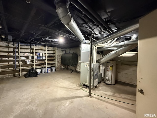 unfinished below grade area featuring heating unit, water heater, and heating fuel