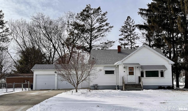 view of front of property with entry steps, concrete driveway, a chimney, roof with shingles, and an attached garage