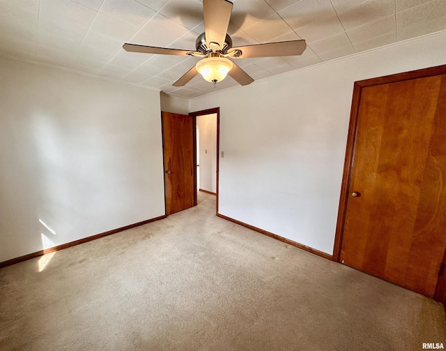 unfurnished room featuring baseboards, a ceiling fan, and light colored carpet