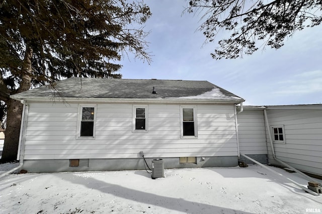 rear view of property with roof with shingles