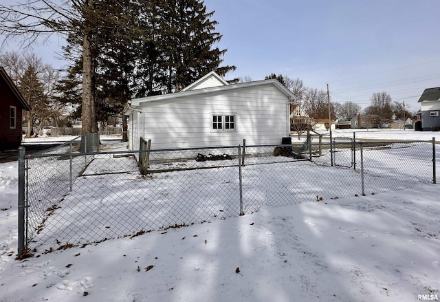 snow covered property with a fenced front yard