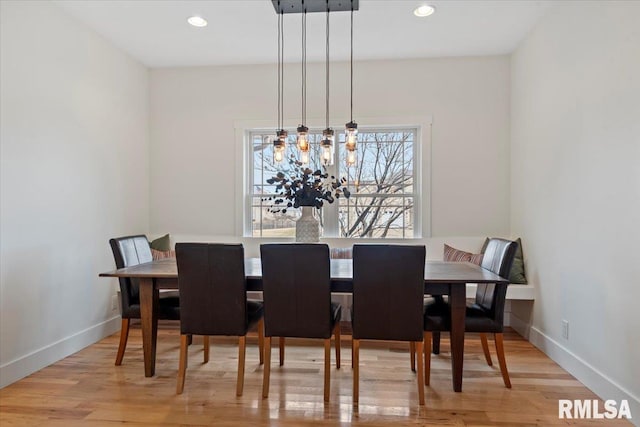 dining area with light wood-style floors, recessed lighting, and baseboards