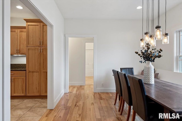 dining room with baseboards, light wood-style flooring, and recessed lighting