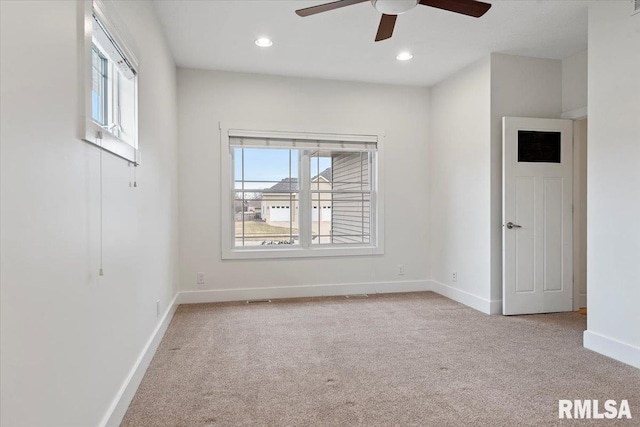 empty room featuring light carpet, baseboards, a ceiling fan, and recessed lighting