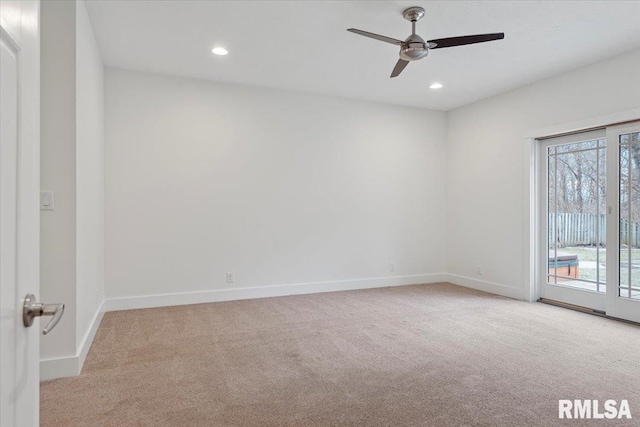 empty room featuring recessed lighting, light colored carpet, and baseboards