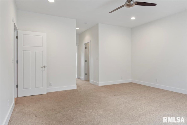 spare room featuring light carpet, baseboards, a ceiling fan, and recessed lighting