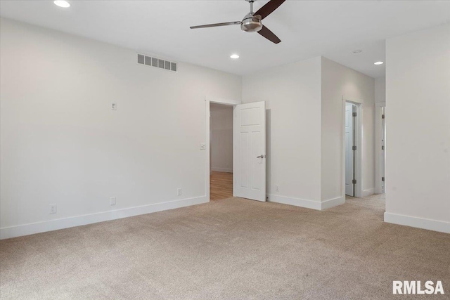 unfurnished bedroom with light carpet, baseboards, visible vents, and recessed lighting