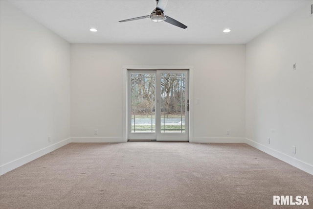 spare room featuring light carpet, recessed lighting, a ceiling fan, and baseboards