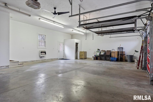 garage with a garage door opener and heating unit