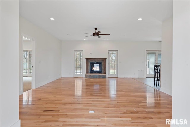 unfurnished living room featuring a healthy amount of sunlight, light wood finished floors, and recessed lighting