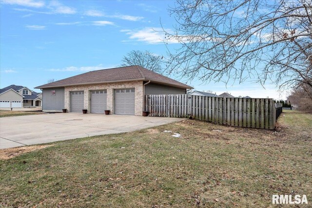 view of property exterior with driveway, a yard, fence, and brick siding