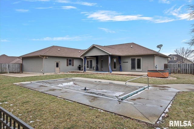 back of house featuring a patio area, fence, and a hot tub