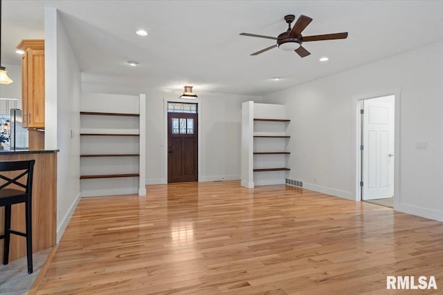 unfurnished living room with recessed lighting, visible vents, ceiling fan, light wood-type flooring, and baseboards