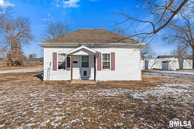 bungalow-style home featuring fence