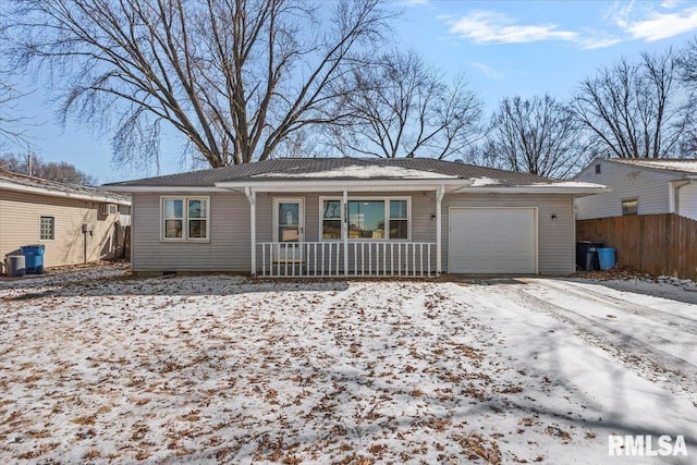 ranch-style home with an attached garage, fence, and a porch