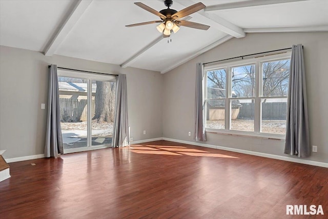 spare room with vaulted ceiling with beams, ceiling fan, wood finished floors, and baseboards