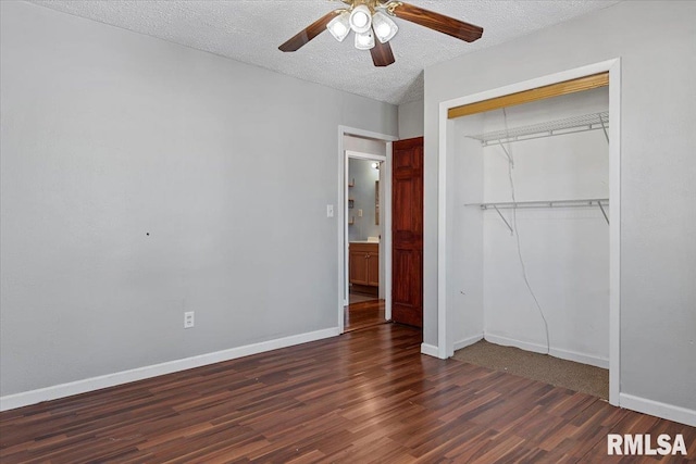 unfurnished bedroom with a textured ceiling, a ceiling fan, baseboards, a closet, and dark wood finished floors