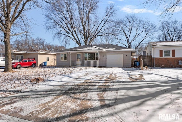 single story home featuring a garage, covered porch, and driveway