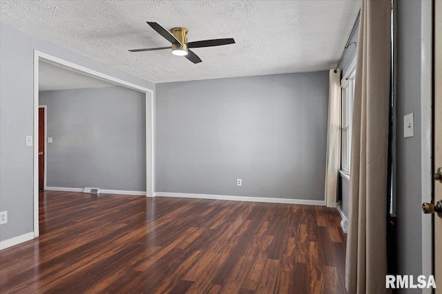 unfurnished bedroom with visible vents, baseboards, ceiling fan, dark wood-style flooring, and a textured ceiling