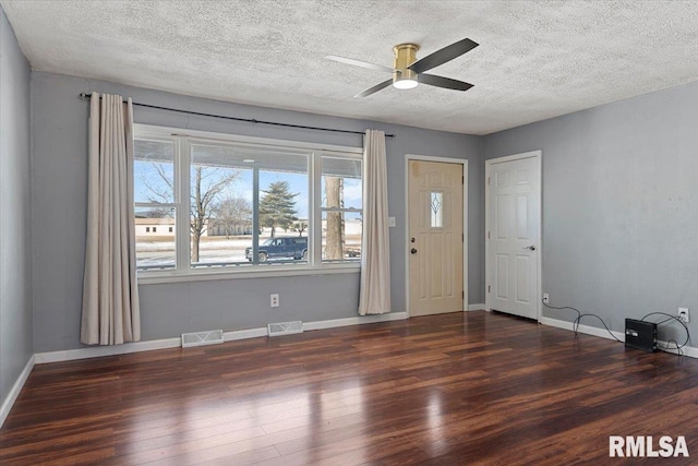 entryway with dark wood-style floors, visible vents, ceiling fan, and baseboards