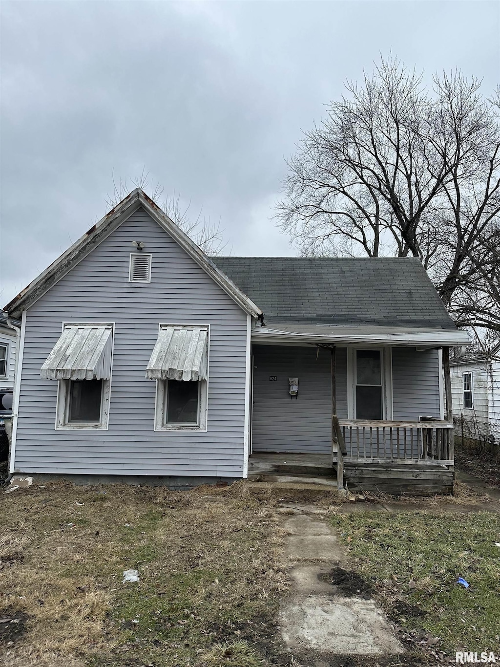 back of property with a porch