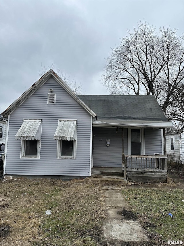 back of property with a porch