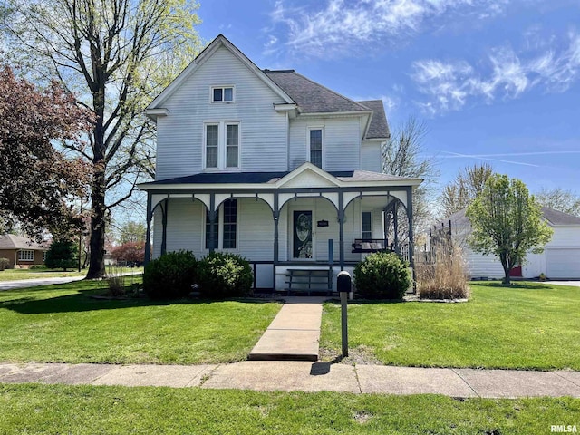 102 W Lorton St, Roodhouse, IL 62082 - view of front of house featuring covered porch, a front yard, and a shingled roof