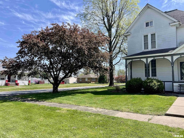 102 W Lorton St, Roodhouse, IL 62082 - view of property exterior featuring a lawn, covered porch, and roof with shingles